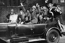 Roaring 20s auto with party revelers in it
